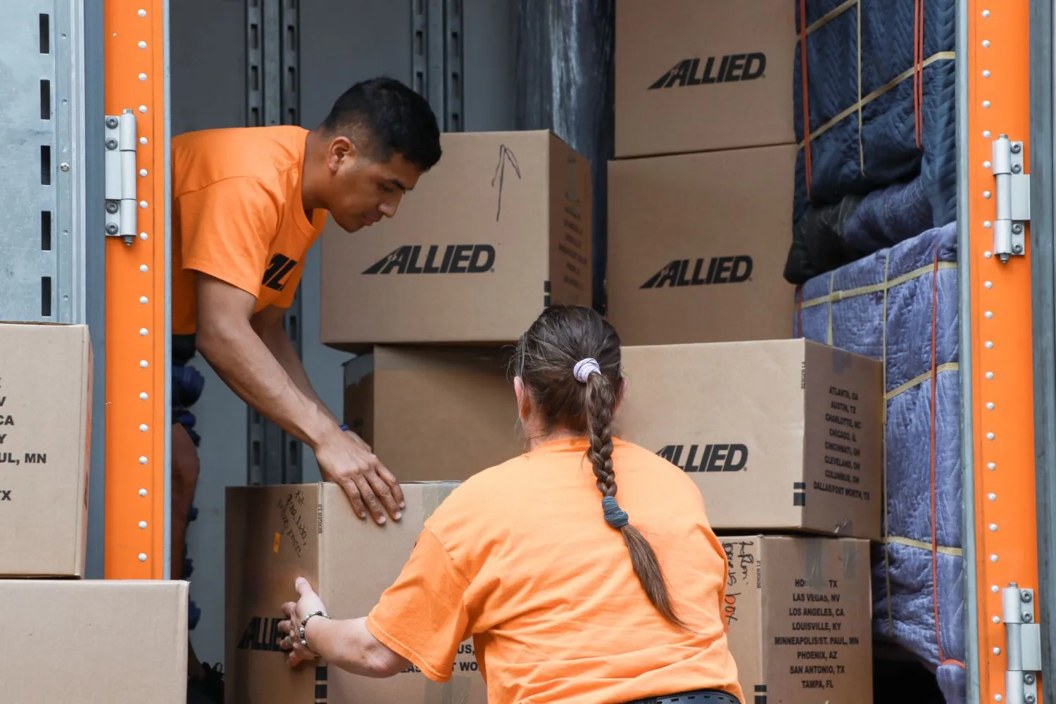 Allied movers stacking boxes in truck